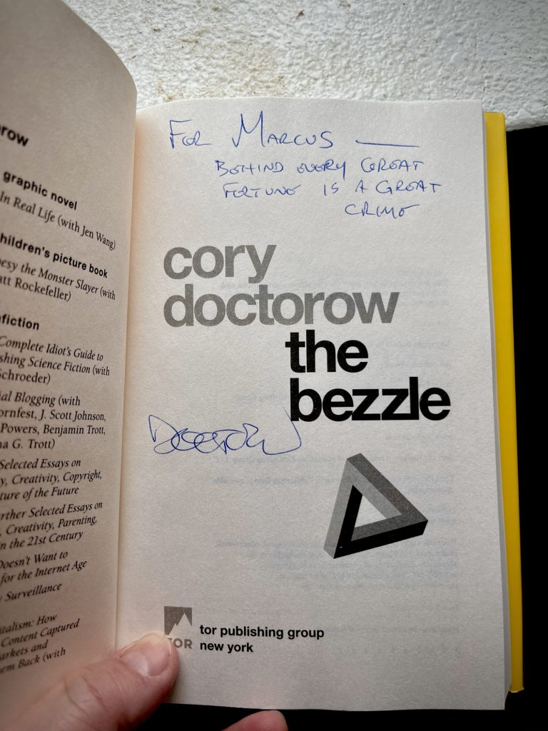 The title page of The Bezzle, signed by Cory Doctorow. It's inscribed, "For Marcus — behind every great fortune is a great crime"